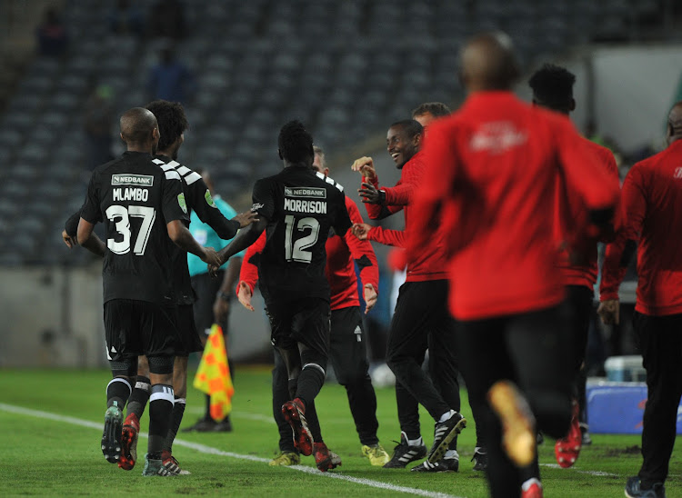 Orlando Pirates' striker Bernard Morrison celebrates with the bench and teammates after scoring a goal during the Nedbank Cup Last 32 match against Ajax Cape Town on 10 February 2018 at Orlando Stadium.
