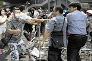 FACE-OFF: Masked attackers try to tear down barricades set up by Occupy Central pro-democracy protesters in Hong Kong