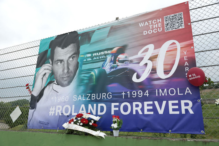 Tributes to Roland Ratzenberger hang from the catch fence during an event to commemorate the 30th anniversary of Ayrton Senna's death at Autodromo Enzo e Dino Ferrari on May 1 2024 in Imola, Italy.