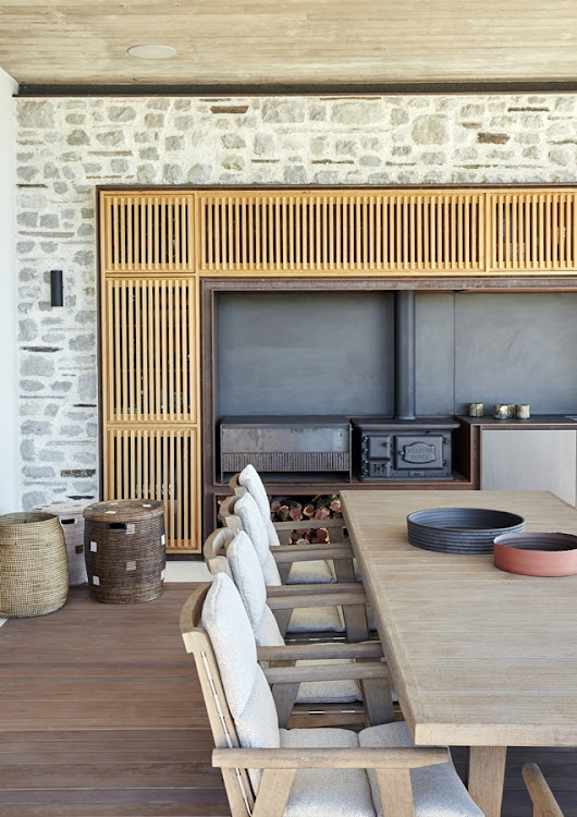 The built-in server on the patio includes a wood-burning stove and a food prep area.