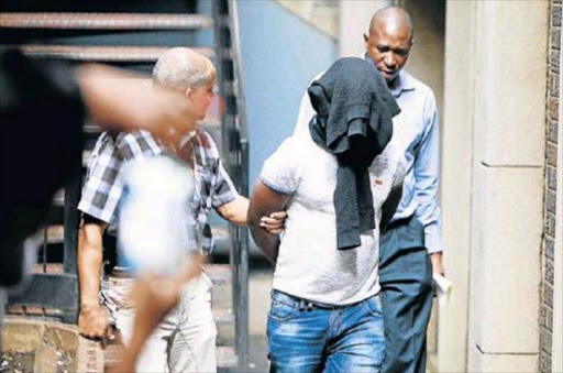 PRETENDER: Tshifiwa Reuben Rudzhadzi, accused of soliciting R250 000 from Oscar Pistorius, on his way to court Picture: SIZWE NDINGANE
