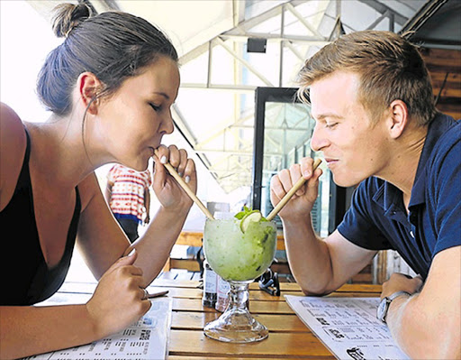 Julie Foster (left) and Russell Whittaker enjoy a mojito through eco-friendly bamboo straws at Sanook eatery in Beacon Bay, which is one of the Eastern Cape restaurants doing its bit to reduce the use of plastic straws which end up choking the oceans Picture: SISIPHO ZAMXAKA