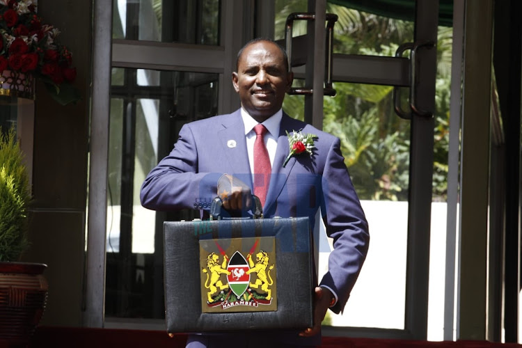 National Treasury CS Ukur Yatani poses for a photo outside the Treasury before leaving for Parliament for Budget presentation on April 7, 2022.