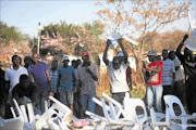 FED UP: Protesters throw chairs that were given to them to sit on while they were being addressed during a service delivery protest in Lanseria.  PHOTO: ALON SKUY