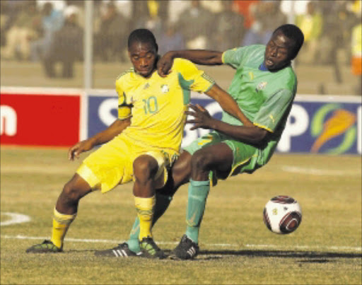 Baby Bafana's Sibusiso Vilakazi tangles with the Young Warriors' Devon Chafa at Sinaba stadium two weeks ago. The second leg takes place in Harare on Sunday and Bafana have a 2-0 lead Picture: RAYMOND PRESTON