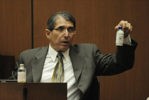 Dr. Paul White, an anesthesiologist and propofol expert, holds a bottle of propofol during the final stage of Dr. Conrad Murray's defense case in the involuntary manslaughter trial in the death of singer Michael Jackson, at the Los Angeles Superior Court in Los Angeles, California, October 28, 2011.