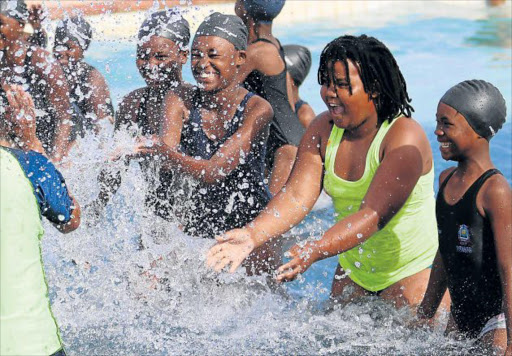 MAKING A SPLASH: Kids from previously disadvantaged backgrounds seen here with swimming instructors at the Orient beach, where they received costumes and some skills in the pool Picture: MICHAEL PINYANA