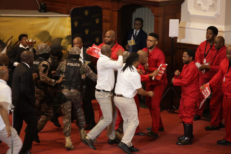 EFF members about to be evicted as President Cyril Ramaphosa attempts to deliver his state of the nation address at the Cape Town City Hall on February 9. Picture: DWAYNE SENIOR/BLOOMBERG