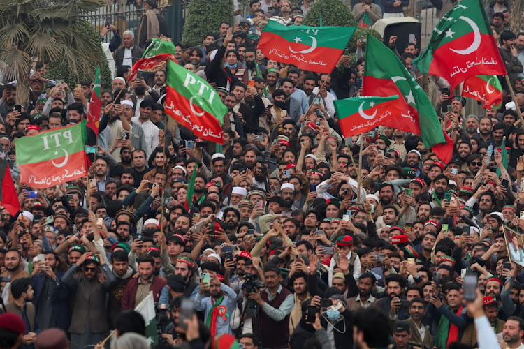 Supporters of former prime minister Imran Khan's party, the Pakistan Tehreek-e-Insaf, wave flags as they protest demanding free and fair results of the elections, in Peshawar, Pakistan February 17 2024. Picture: FAYAZ AZIZ/REUTERS