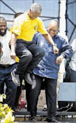 President Thabo Mbeki flanked by a smiling Cosatu president Willie Madisha and a beaming ANC Deputy President Jacob Zuma. Pic. Sithembile Lushozi. © Unknown.