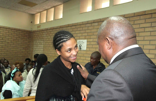 RELAXED: Melice Jacobs, 29, who is facing four counts of murder and a concealment of birth charge, made a brief appearance at the Mthatha Magist rates Court yesterday. She is seen here having a conversation with her lawyer, Mpumelelo Notununu Picture: LULAMILE FENI