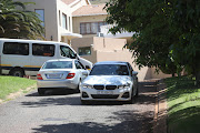 The entrance to Nosiviwe Mapisa-Nqakula's residence is blocked by several vehicles.