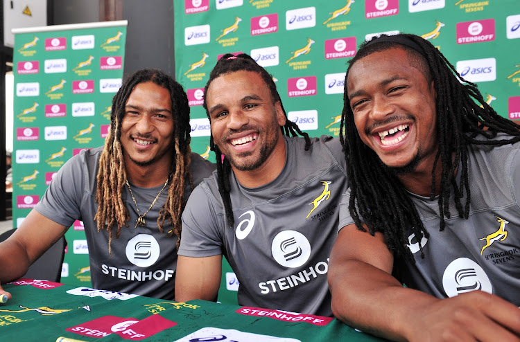 The Blitzboks players Justin Geduld, Rosko Specman and Branco du Preez pose for a picture during the South Africa Sevens Team autograph signing session at the V&A Waterfront in Cape Town on 6 December 2017.