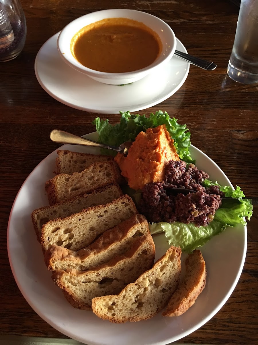 Gluten free bread, toasted, with hummus and tapenade (appetizer) and Fish Soup—tomato based soup puréed.