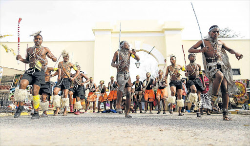 CULTURAL BUZZ: Tsembeyi cultural group, from Lady Frere, perform outside the Drostdy Arch at the Grahamstown Arts Festival Picture: STEPHANIE LLOYD