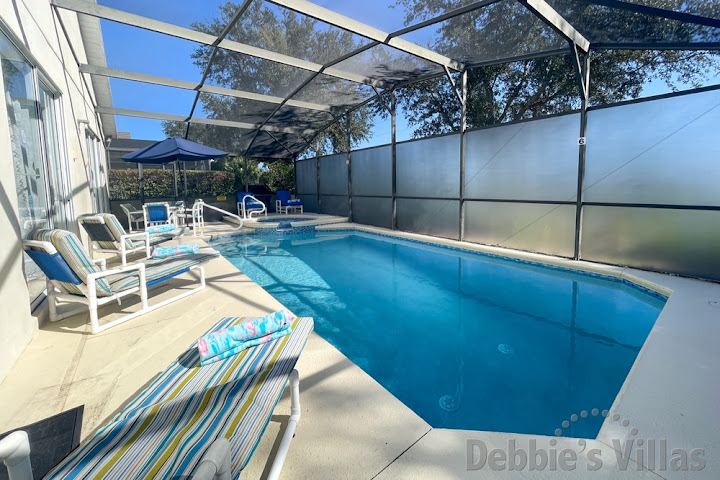 Sunny pool and spa deck at this Clermont vacation villa