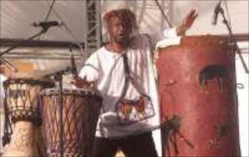 HYPNOTIC DRUMS: Sello Kgalane perfrming on stage during Macufe in Bloemfontein. Pic. Clement Lekanyane. 09/10/05. © Sowetan.