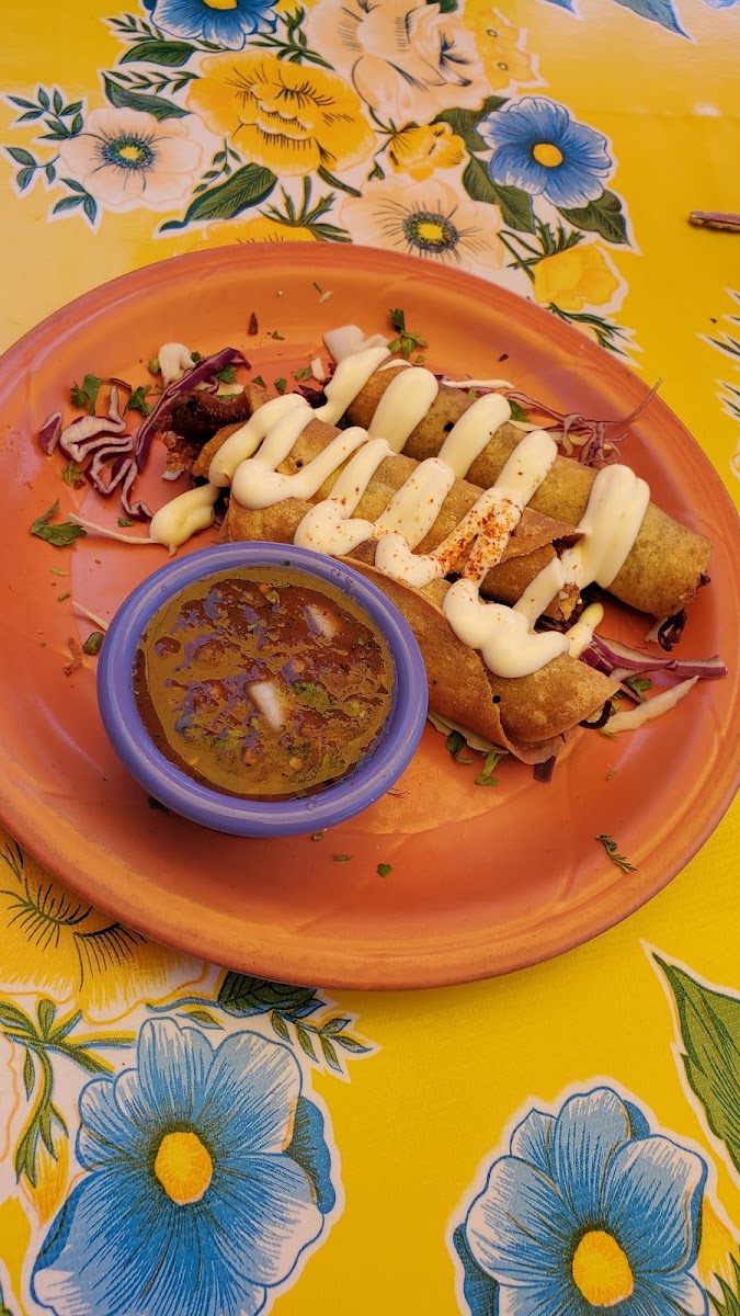 Carnitas flautas made with corn tortillas in a dedicated fryer