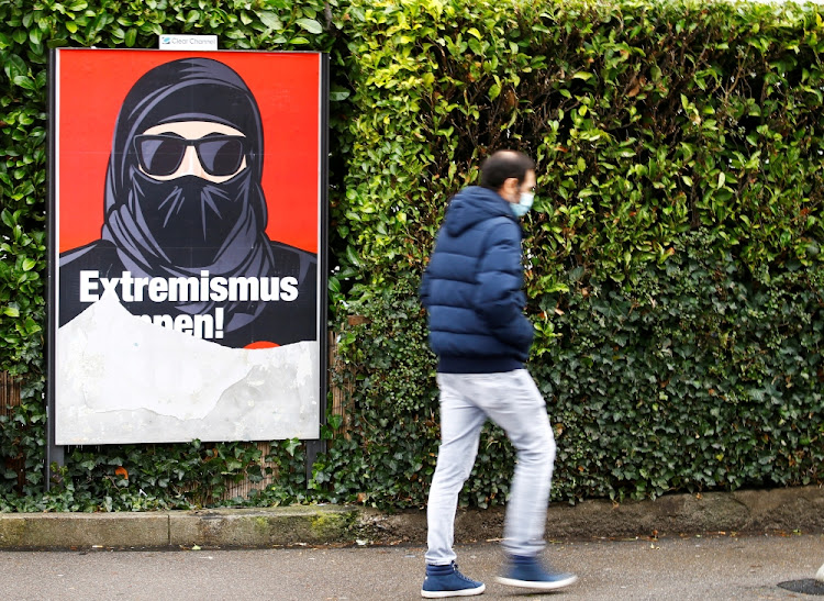 A partially torn poster of the initiative committee against wearing the burqa (Verhuellungsverbot) reading "Stop extremism! Veil ban -Yes" is seen in Zurich, Switzerland February 2, 2021. On March 7 Switzerland's voters will decide about a nationwide veil ban.