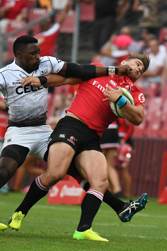 Lwazi Mvovo of the Sharks tackles Rohan Janse van Rensburg of the Lions during the Super Rugby match at Emirates Airline Park on April 01, 2017 in Johannesburg, South Africa.