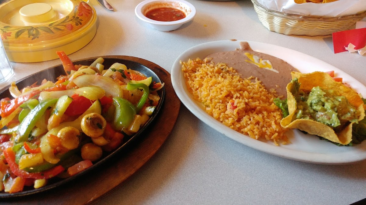 Gluten free steaming veggie  fajitas served with rice, beans and yummy guacamole. Fresh corn tortillas if you eat corn (not me) but I took just a wee taste. Warm and friendly atmosphere too!