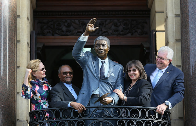 The statue of Nelson Mandela on the balcony at Cape Town City Hall after its unveiling by‚ (from left)‚ Western Cape Premier Helen Zille‚ Nelson Mandela Foundation chairman Njabulo Ndebele‚ Cape Town mayor Patricia de Lille and Western Cape tourism and economic opportunities MEC Alan Winde on July 24 2018