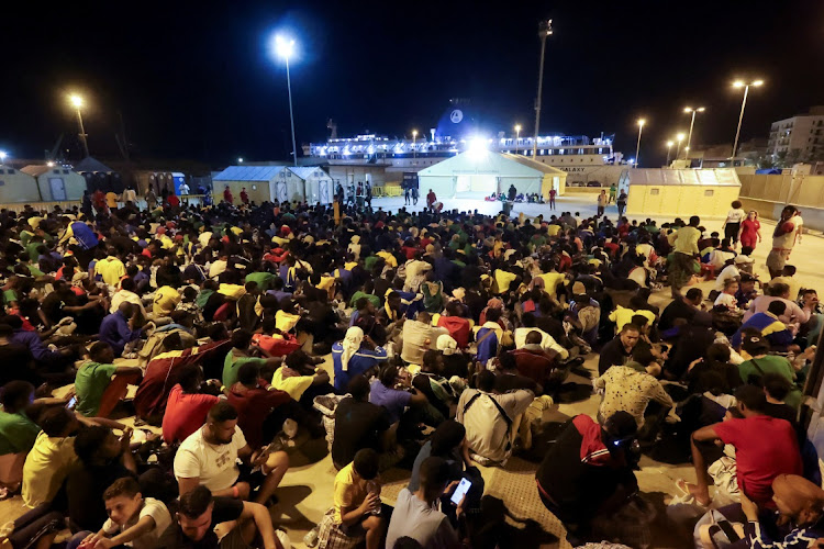 Migrants rest after disembarking from a ferry in the Sicilian harbour of Porto Empedocle, Italy, September 13, 2023. Picture: REUTERS