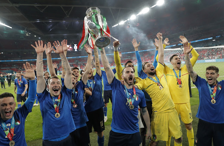 Leonardo Bonucci lifts the trophy as the Italians celebrate victory after Euro 2020 final against England at Wembley Stadium in London on July 11 2021.