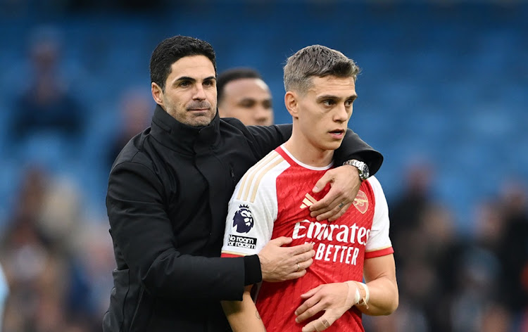 Arsenal manager Mikel Arteta with Leandro Trossard during the Premier League match against Manchester City at Etihad Stadium on Sunday.