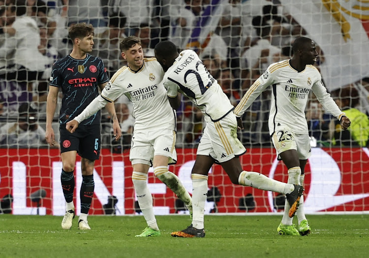 Real Madrid's Federico Valverde celebrates scoring their third goal with Ferland Mendy and Antonio Rudiger in their Uefa Champions League quarterfinal first leg against Manchester City at Santiago Bernabeu in Madrid on Tuesday night.