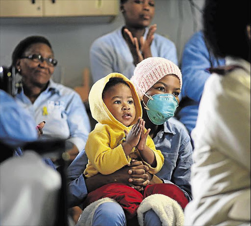 LOVING SUPPORT: Frere Hospital patient Mbali Nxanga with her younger brother, Zenani, 2, watches the motivational video created by Choc (Childhood Cancer Foundation) at the start of Childhood Cancer awareness month Picture: MARK ANDREWS