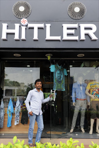 Rajesh Shah poses in front of his shop. File photo.