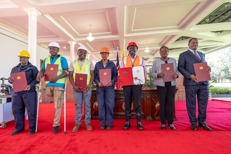 President William Ruto with Lands and Housing CS Alice Wahome, Attorney General Justin Muturi ane other stakeholders after he signed into law the Affordable Housing Bill at State House, Nairobi on March 19, 2024.