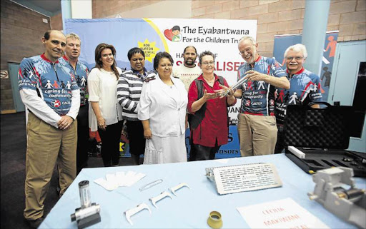 WORTHY CAUSE: Cecilia Makiwane Hospital’s Mia Elsen (in red shirt) receiving some of the new burn equipment from Colin Lazarus at the Health and Resource Centre yesterday Picture: MARK ANDREWS