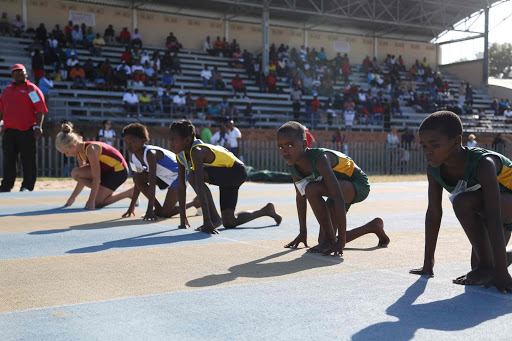 ALL SET: Young runners get to their marks at the start of a track race at the provincial primar y school track and field championships at Jan Smuts Stadium Picture: MARK ANDREWS
