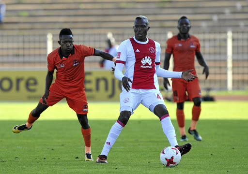 Tendai Ndoro of Ajax Cape Town is challenged by Mondli Miya of Polokwane City during their PSL match at the Old Peter Mokaba Stadium in February.