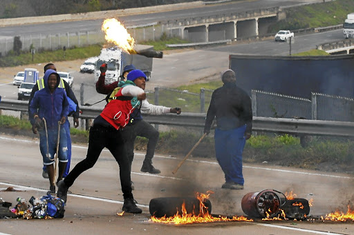 Zuma supporters block the N3 at Peacevale, on the outskirts of Durban at the weekend, as violence erupted over the jailing of former president Jacob Zuma. Violent protests have spread to other areas.