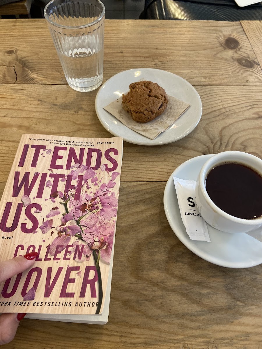 Enjoying a nice read with some coffee and a cookie!