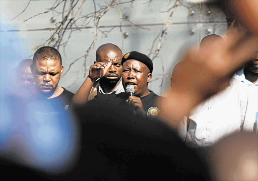 ANC Youth League president Julius Malema addresses his supporters in downtown Johannesburg during a break in his disciplinary hearing, yesterday. His hearing has been moved to a secret location after his supporters rioted in the city centre Picture: LEBOHANG MASHILOANE