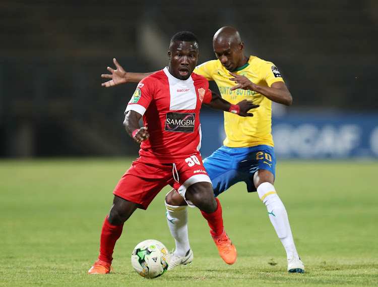 Mandela Ocansey of Horoya SC is challenged by Anele Ngcongca of Mamelodi Sundowns during the Caf Champions League match at the Lucas Moripe Stadium in Atteridgeville, west of Pretoria, on August 28 2018.
