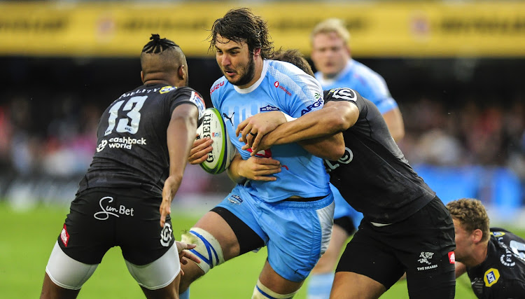 Lood de Jager of the Vodacom Bulls (C) runs into the defence of Andre Esterhuizen (R) and Lukhanyo Am (L) of the Cell C Sharks during the Super Rugby game at Kings Park in Durban on 14 April 2018.