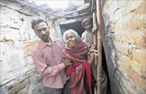 GRIEVING: The brother, mother Ram Bai and father Mange Lal Singh of Ram Singh, who died in Tihar Jail. Photo: REUTERS
