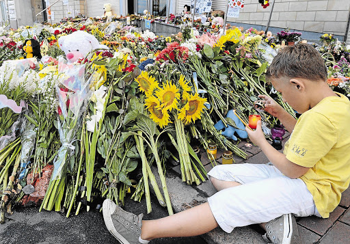 LET THERE BE LIGHT: Tributes outside the Dutch embassy in Kiev, Ukraine to the people who died when Flight MH17 was shot down