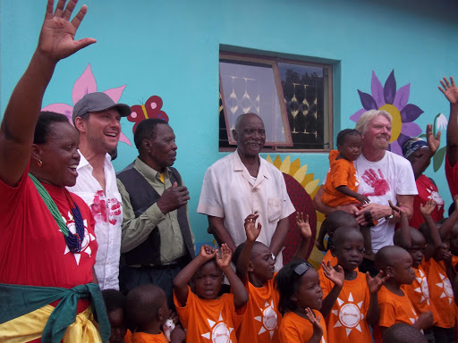 Christian Slater (second from left) and Richard Branson (far right) with members of the Dumphries community and some of the children who will be attending the Akani Creche.