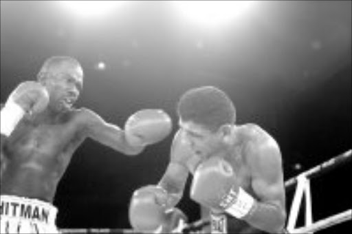 TAKE THAT: Cassius Baloyi punches Nazareno Ruiz in their IBO vacant junior lightweight scrap at Emperors Palace on Saturday. Pic. Antonio Muchave. 04/02/2007. © Sowetan.