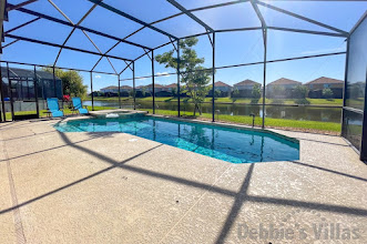 Stunning lake view from the sun-drenched pool deck at this Kissimmee vacation villa