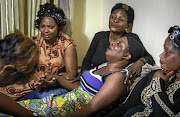 Antho Mpianzi, the mother of drowned Parktown Boys' High pupil Enock, is comforted by mourners on January 17 2020. 