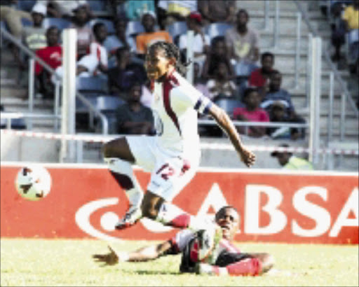 HO TO IT: Moroka Swallows' Lefa Tsutsulupa is tackled by Platinum Stars' Joseph Mkalipa during their Absa Premiership match at Orlando Stadium in Soweto yesterday. 23/11/2008. © Sowetan. Pic. Veli Nhlapo.