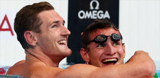 Cameron van der Burgh celebrates winning the men's 50m breaststroke final with Giulio Zorzi at the 15th Fina world championships at Palau Sant Jordi in Barcelona, Spain, on July 31 2013.