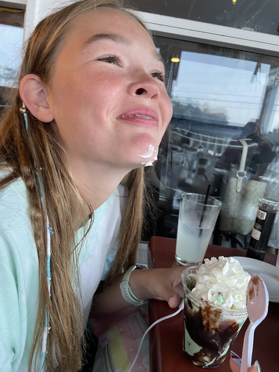 Being silly with her mint/hot fudge sundae (no Lindt chocolate though as they are not GF)